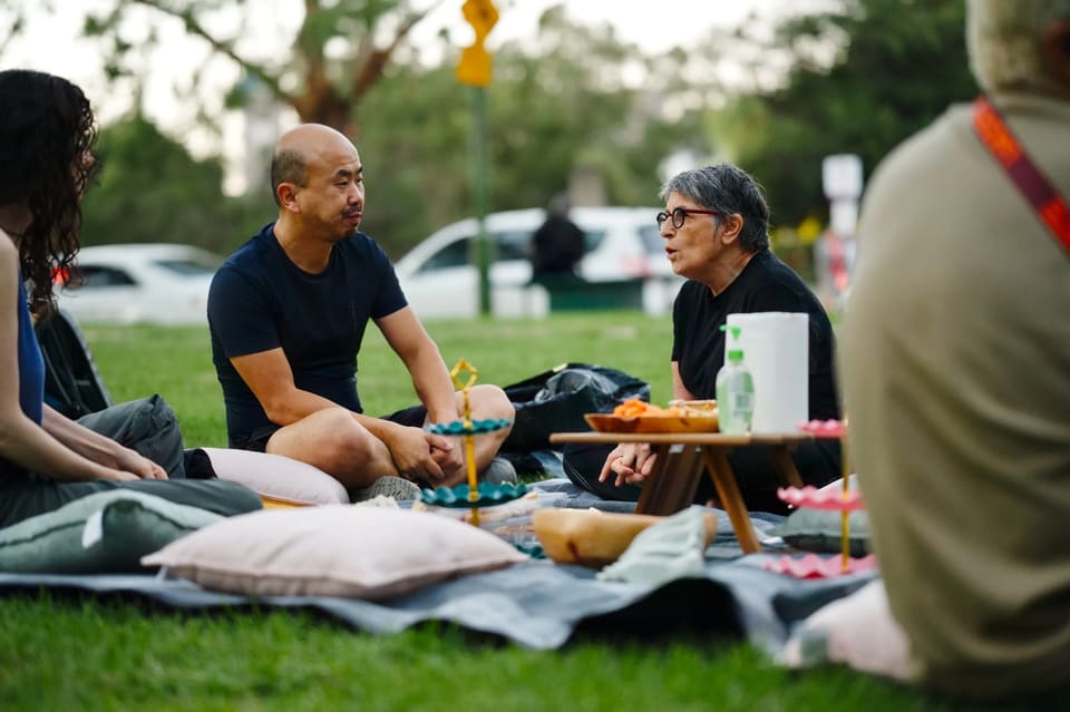 A man and a woman talking at a picnic